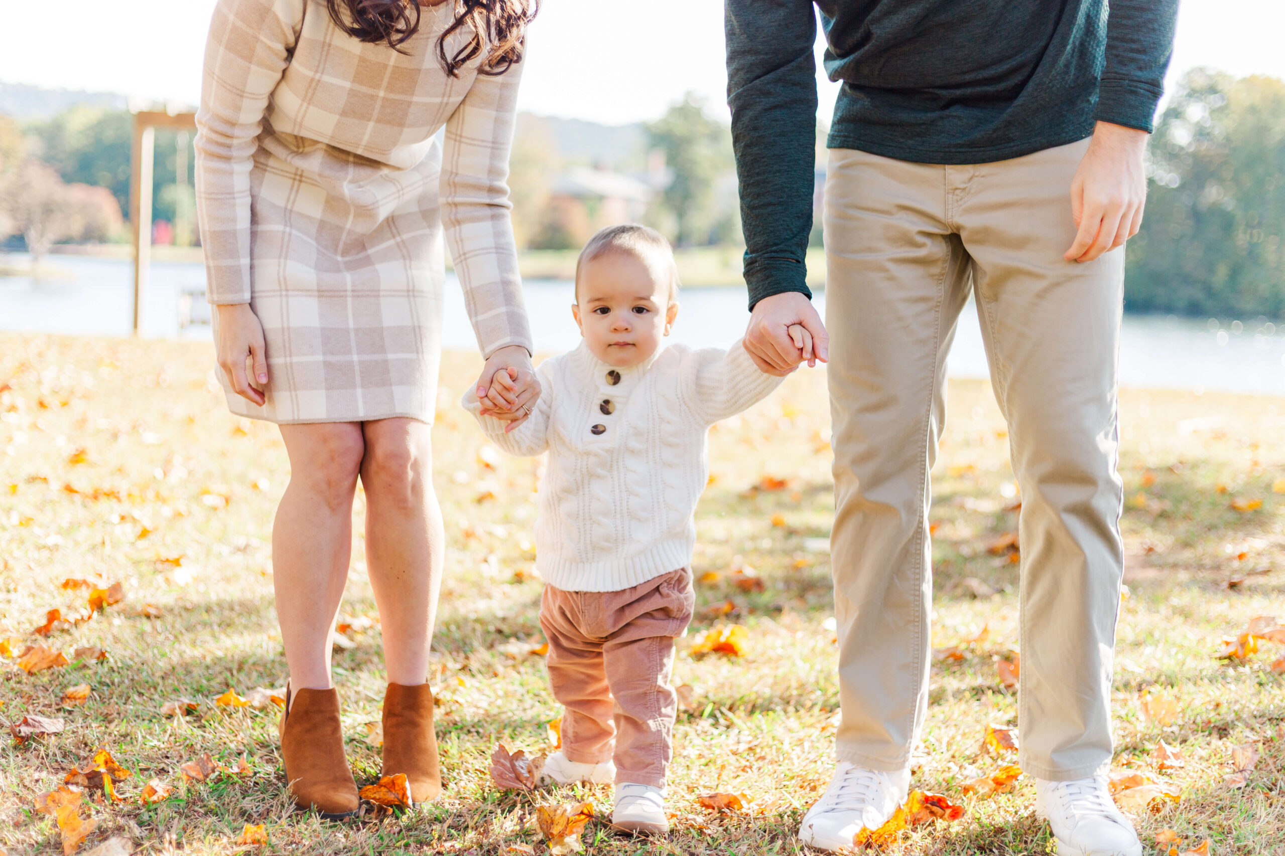 Family walking beside the lake at Furman University in Greenville, South Carolina.