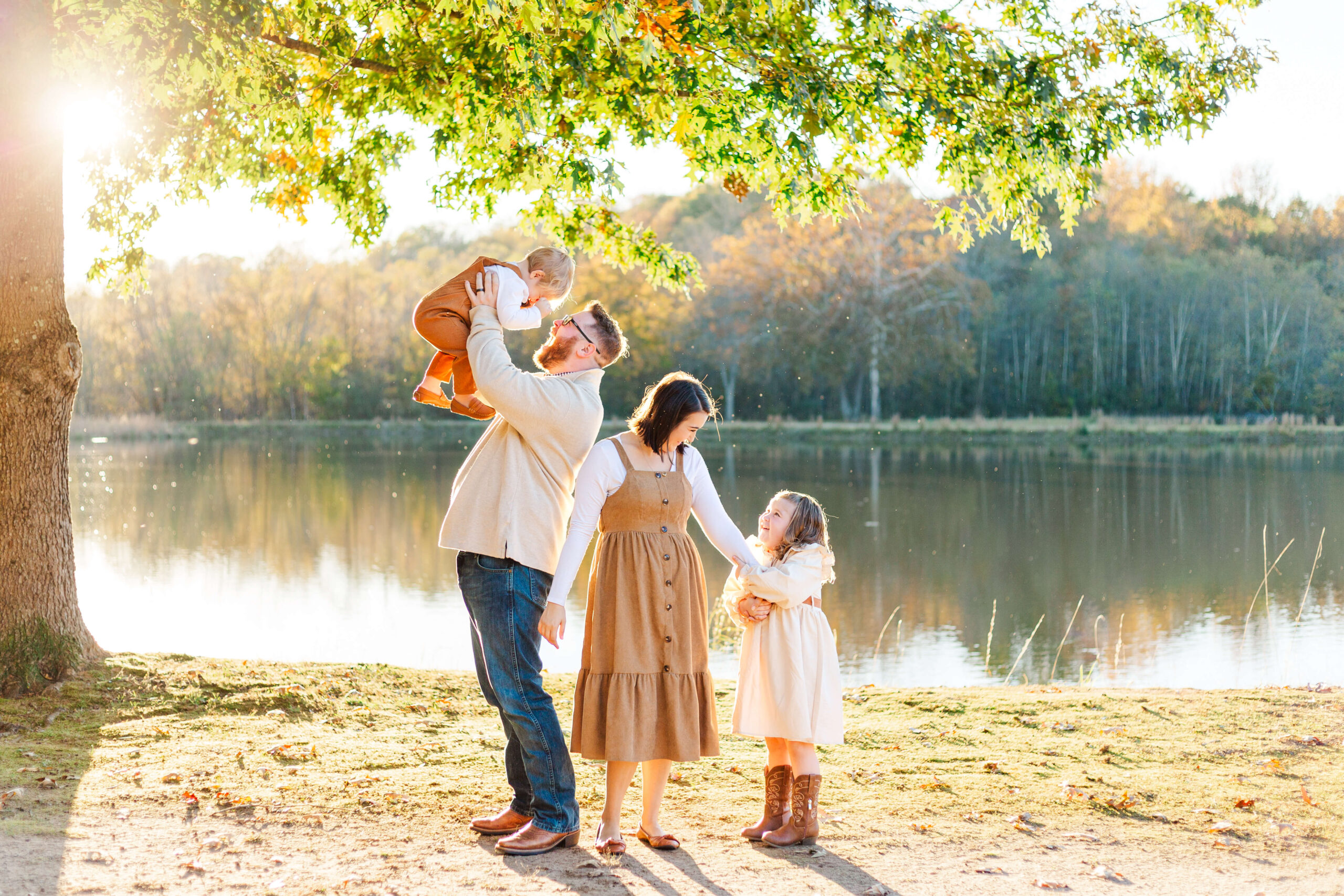 Father laughing with his children during fall family photos in Seneca South Carolina