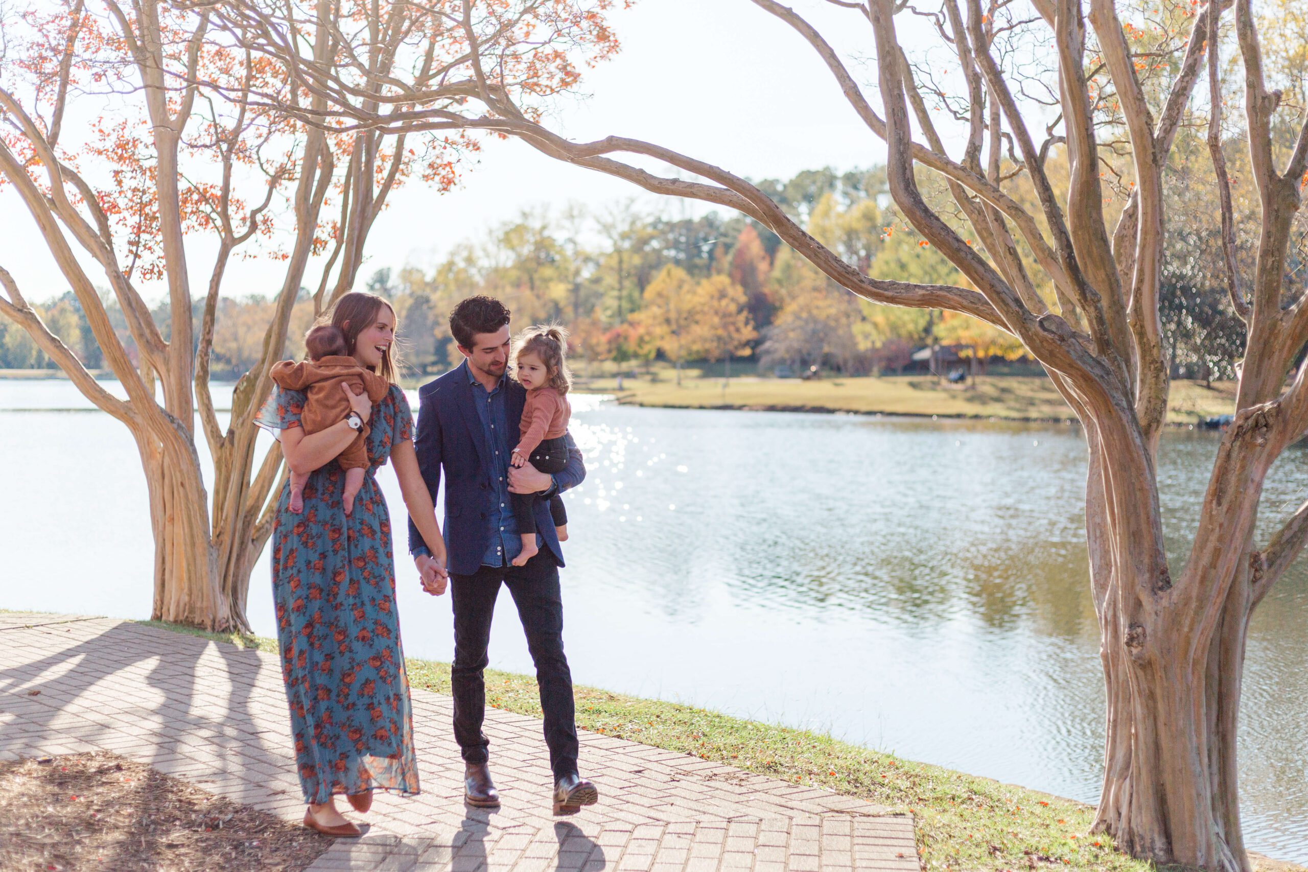Parents cuddling their two young children during a warm fall evening in Taylors, SC